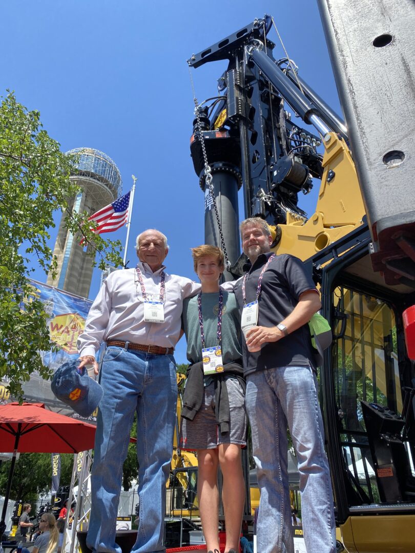 David, Parker and Doug Watson posing in front of drilling rig