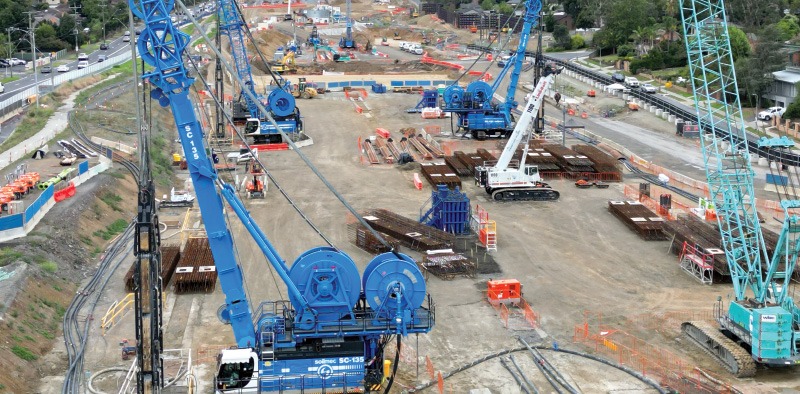 Various heavy machinery on project site.