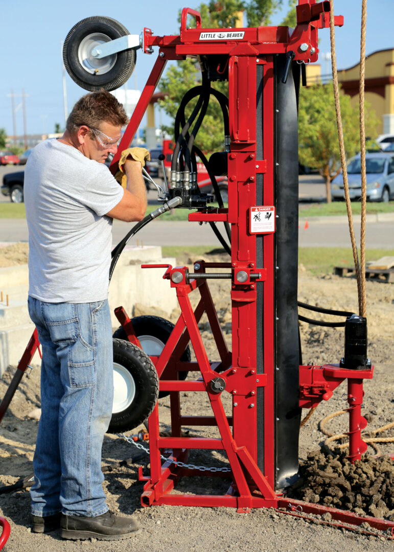 Contractor operating a hollow stem auger