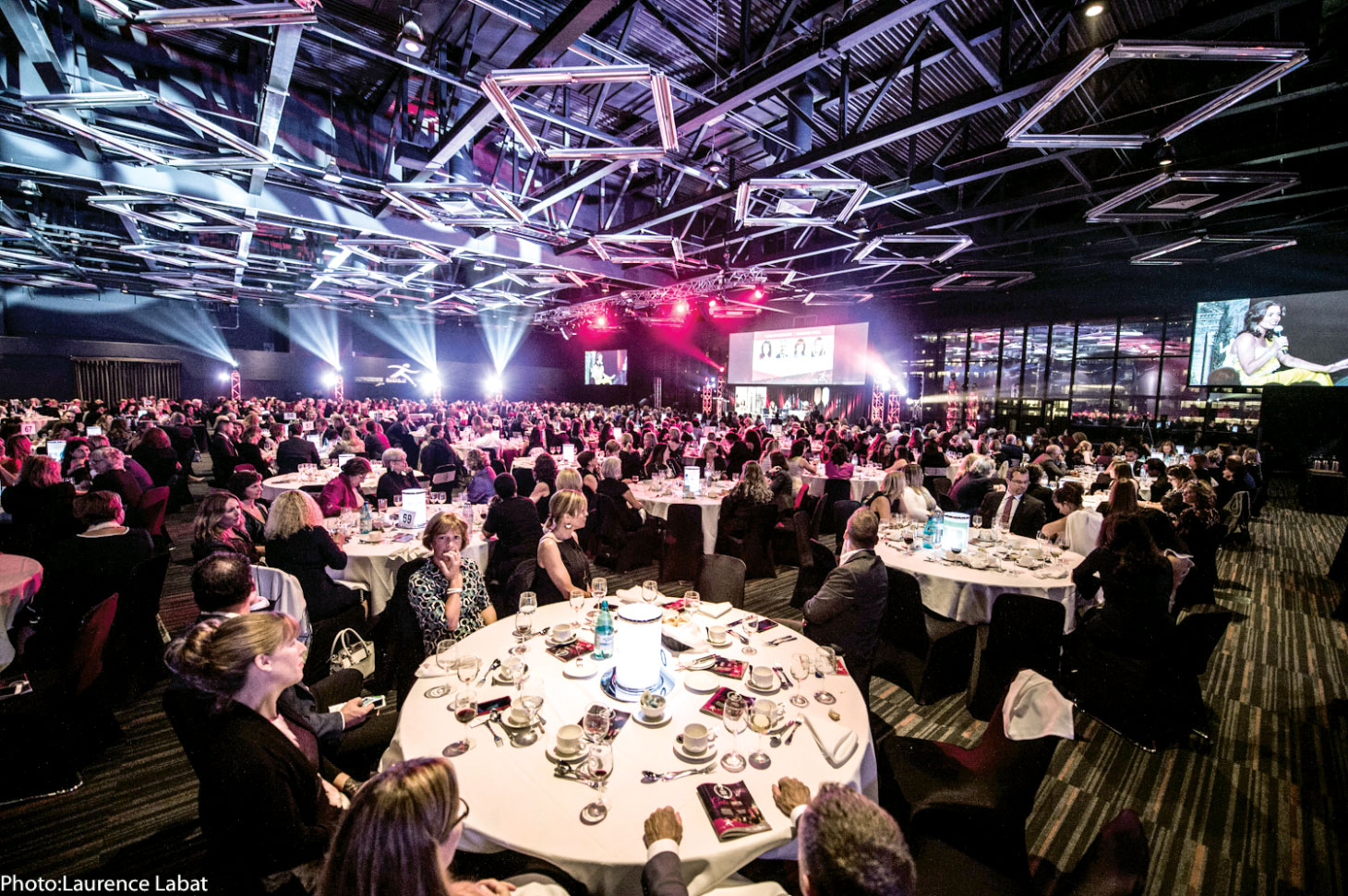 Wide angle shot of stage with attendees in foreground