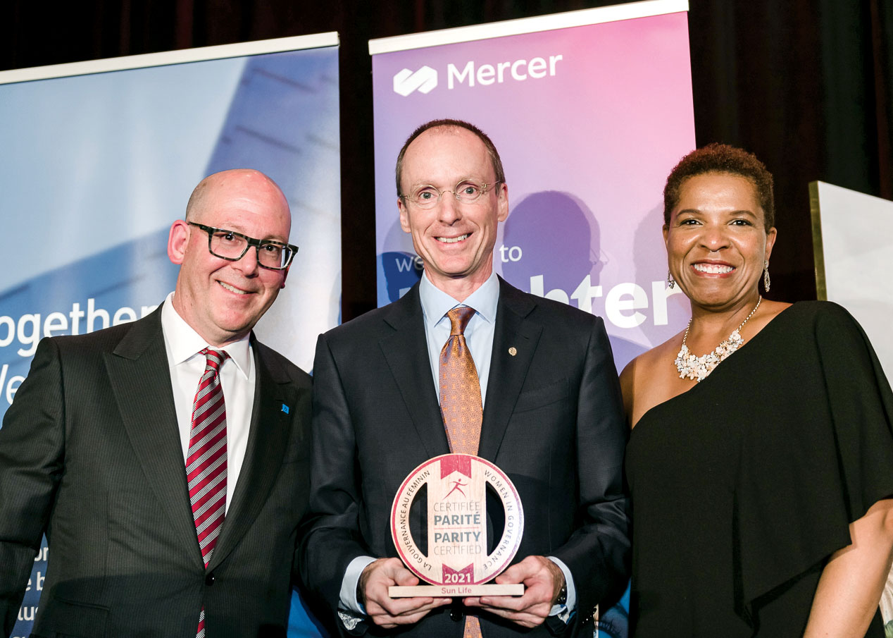 Jacques Goulet holding Platinum-level Parity Certification trophy flanked by Anthony Ostler and Nicole Piggott