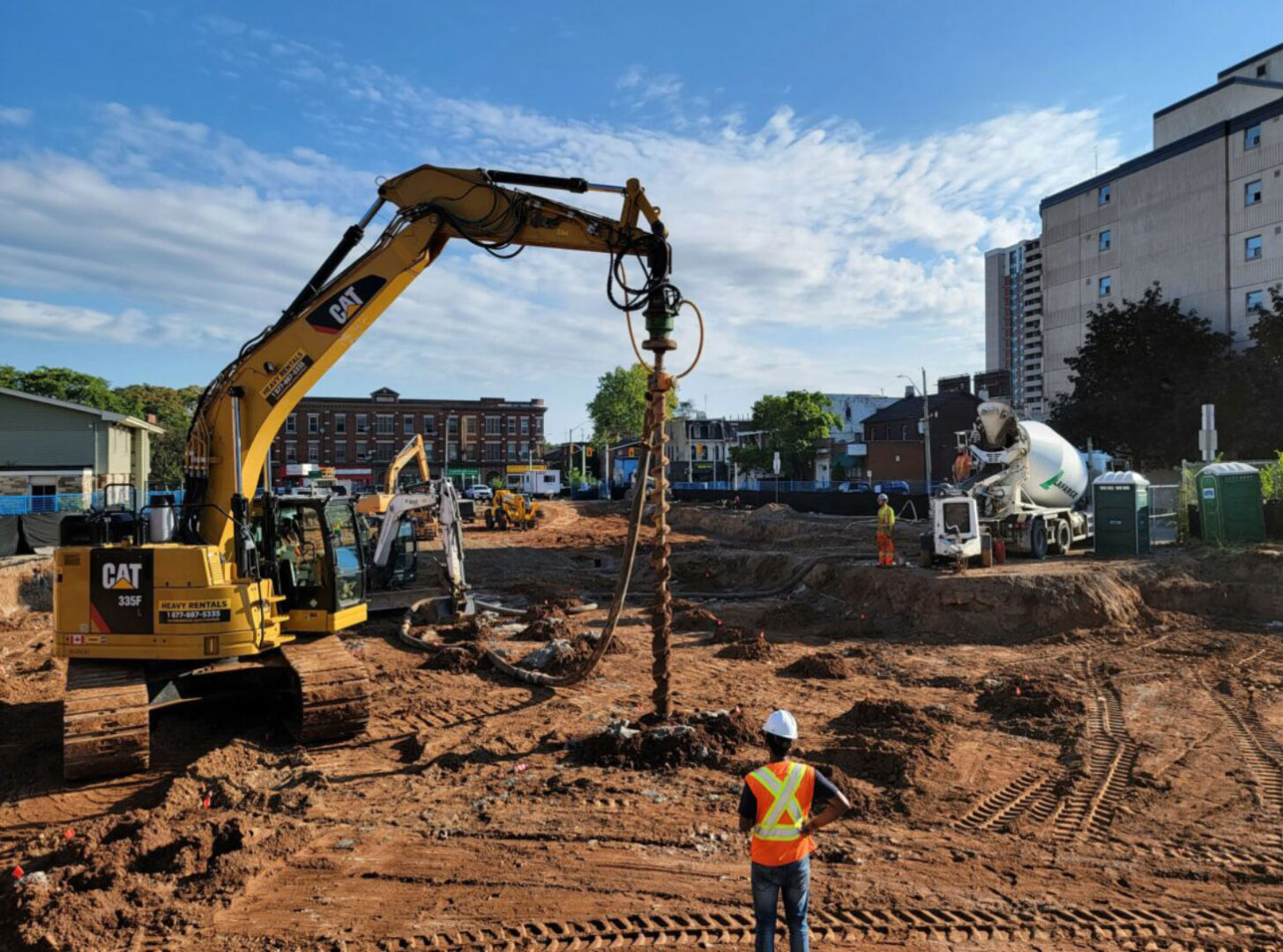 Workers and heavy machinery on construction site