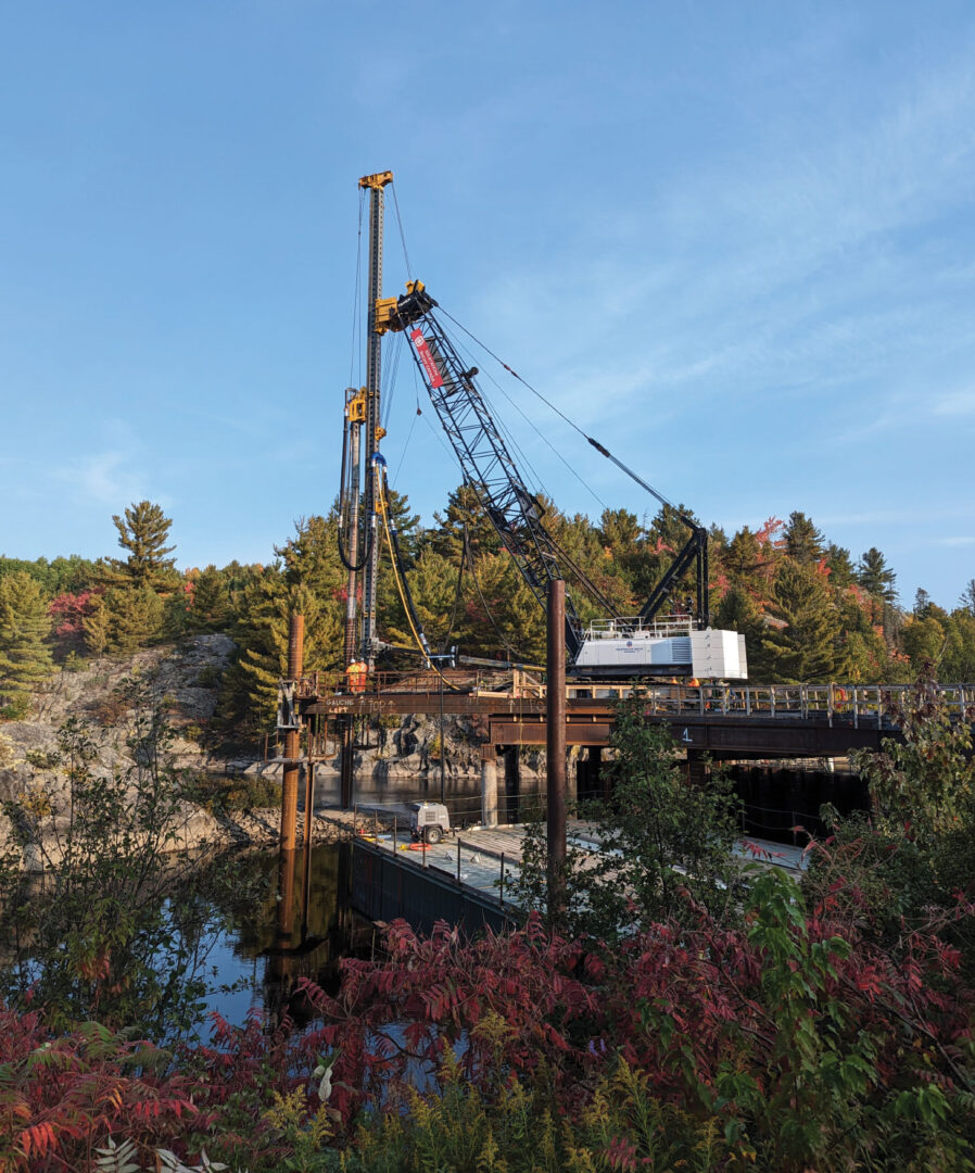 Heavy equipment driving piles at Nairn Falls generating system