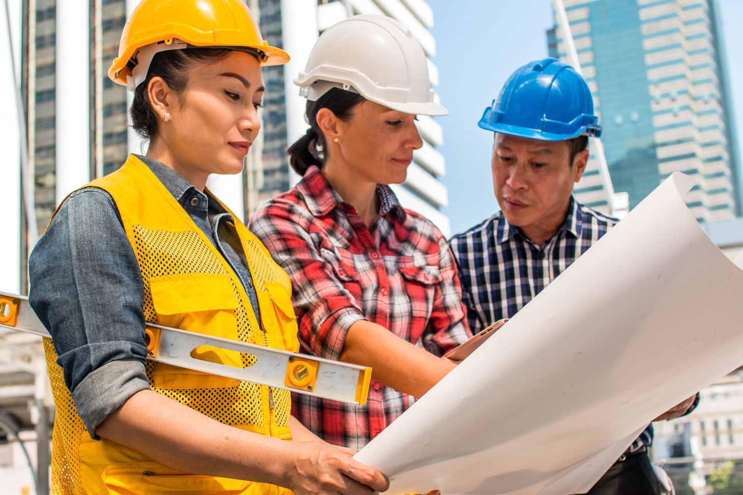 Construction workers looking at technical drawings