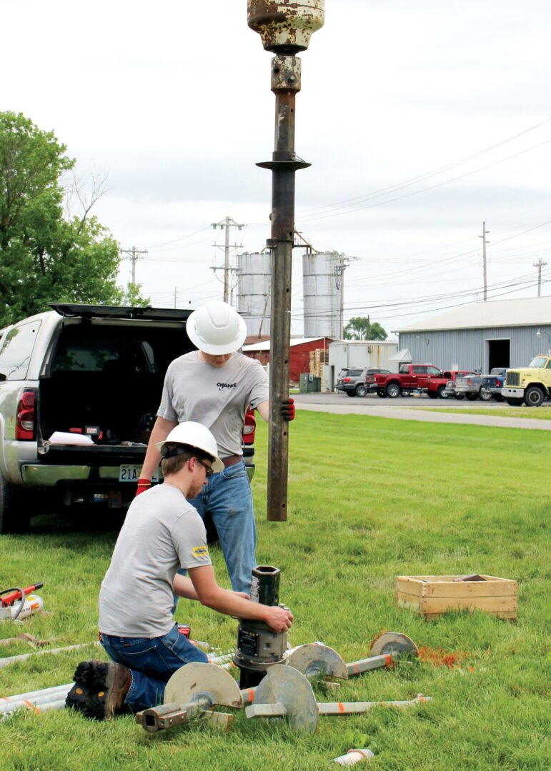 Two men installing drill