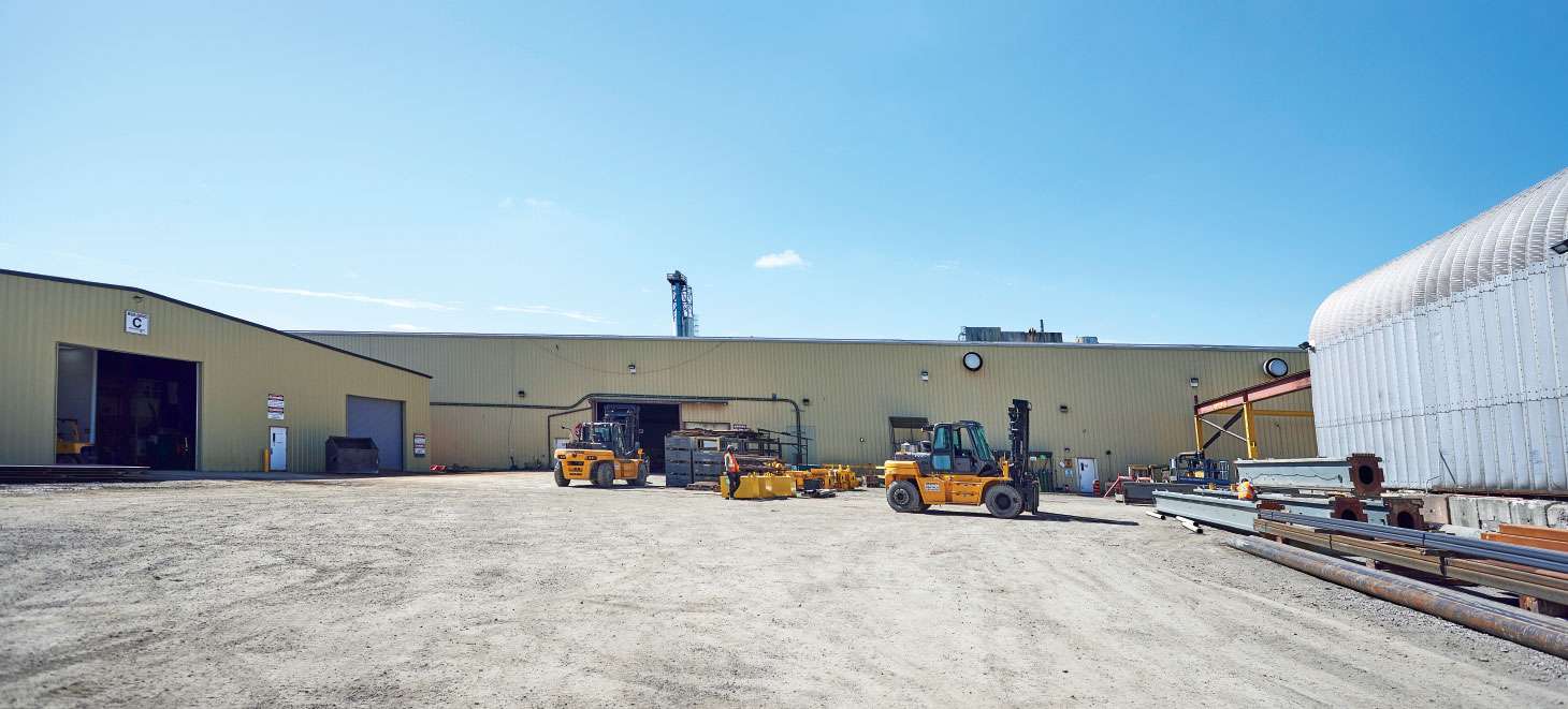 Forklifts with facility in background