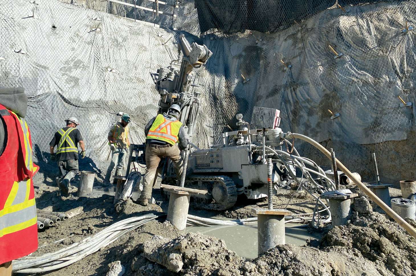 Workers installing micropiles