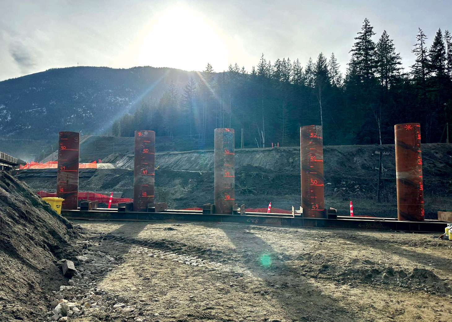 Installed piles with sun setting in background