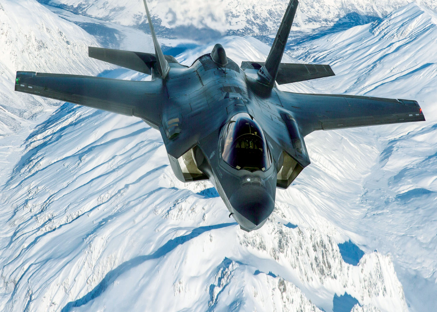 CF-35A fighter jet above snowy mountaintops