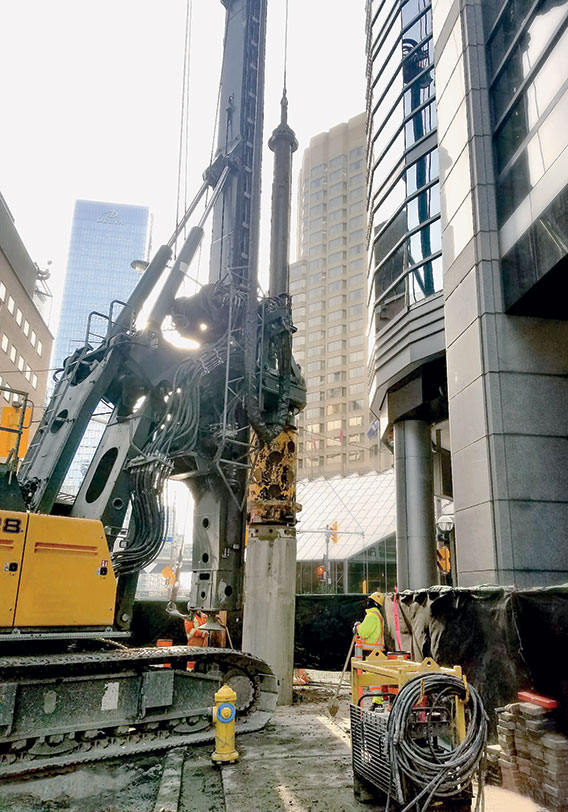 Workers installing piles