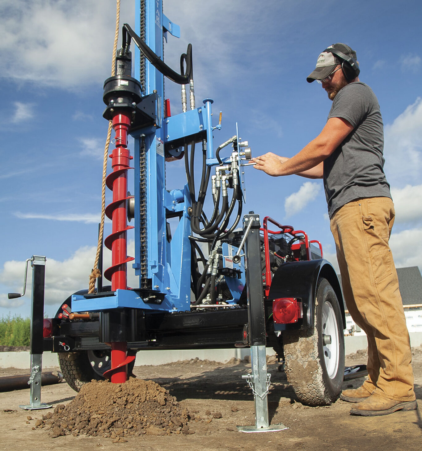 Man operating retrieving sample with auger