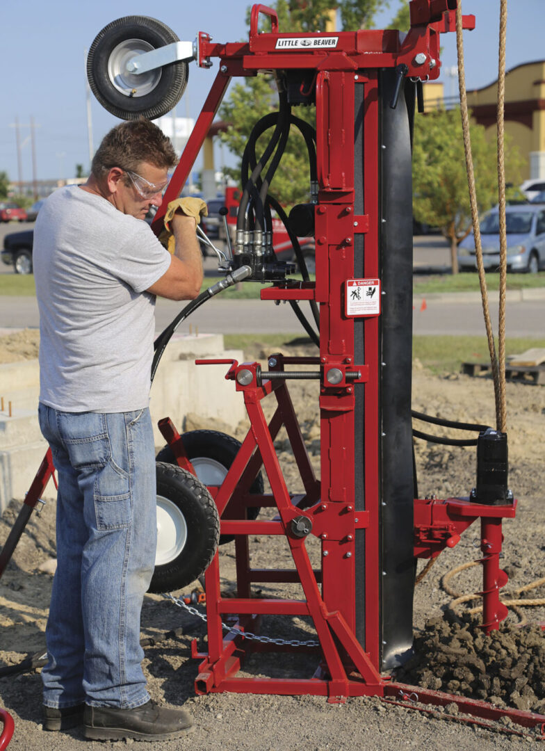 Man operating retrieving sample with auger