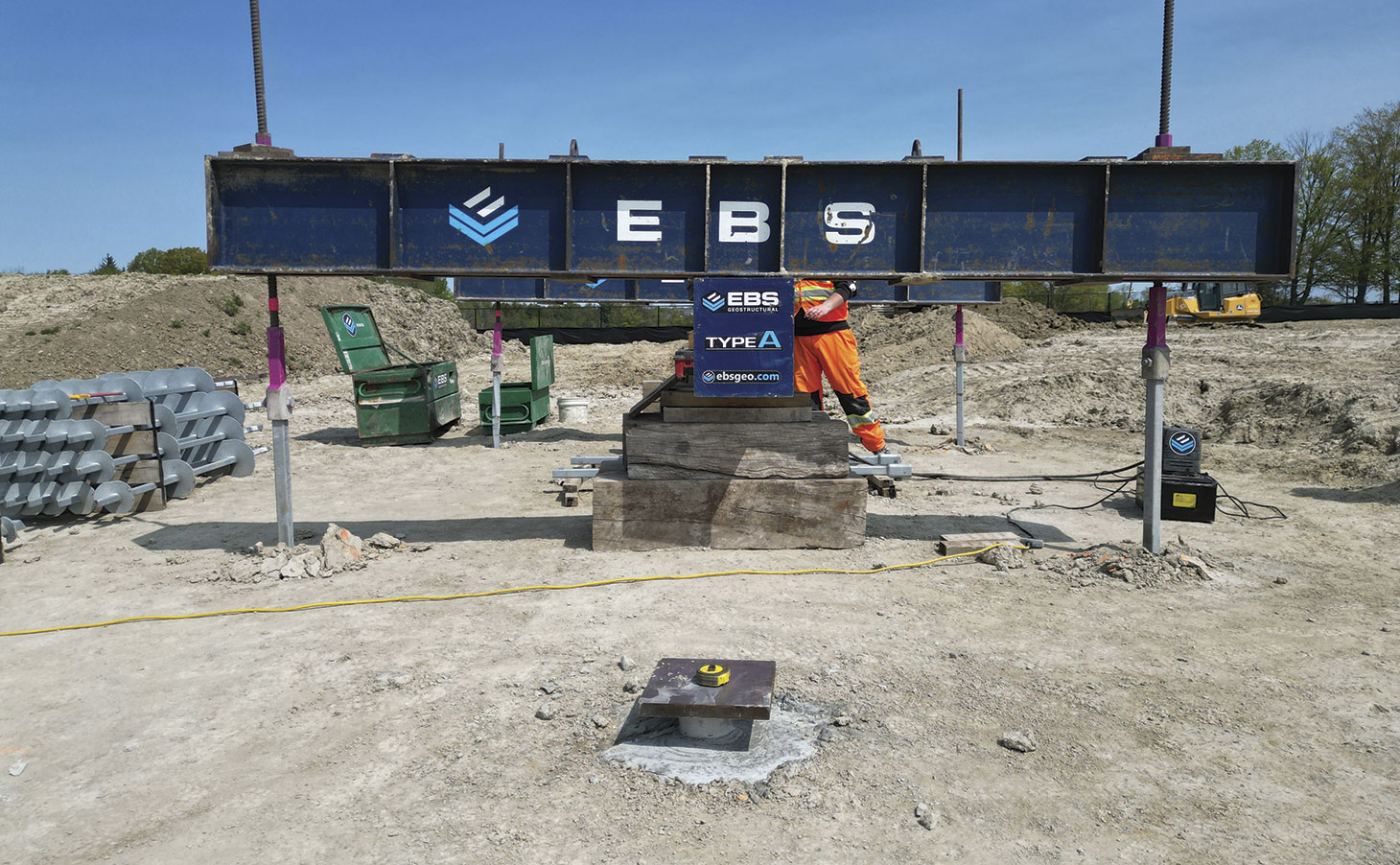 Blue steel support beam with EBS logo painted on it.