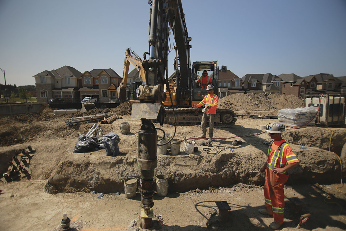 Workers and heavy equipment operating on construction site