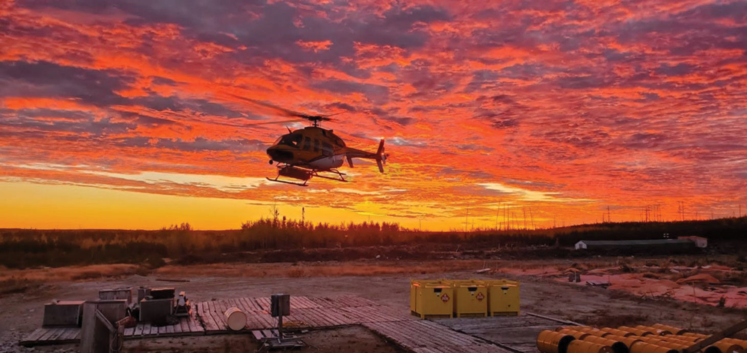 Helicopter lifting off against gorgeous sunrise