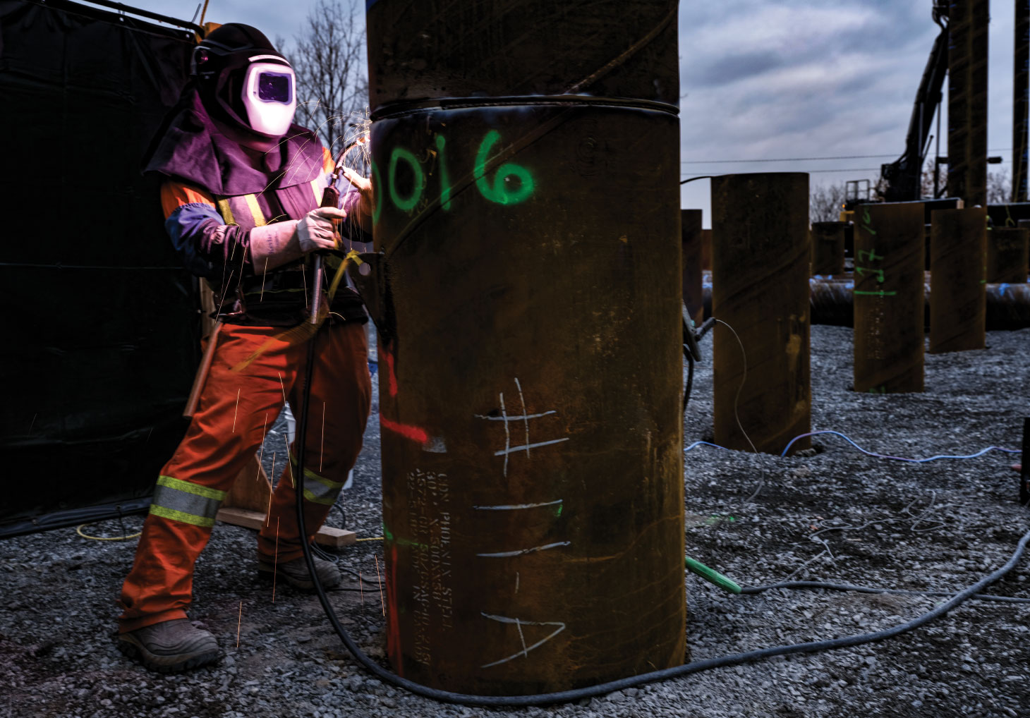 Welder working on large pipe