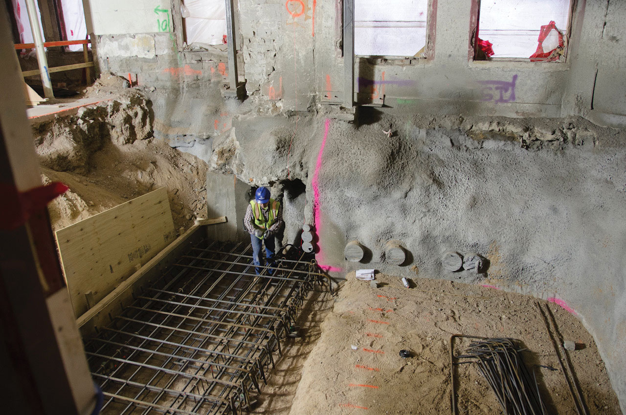 Worker in dug up building foundation