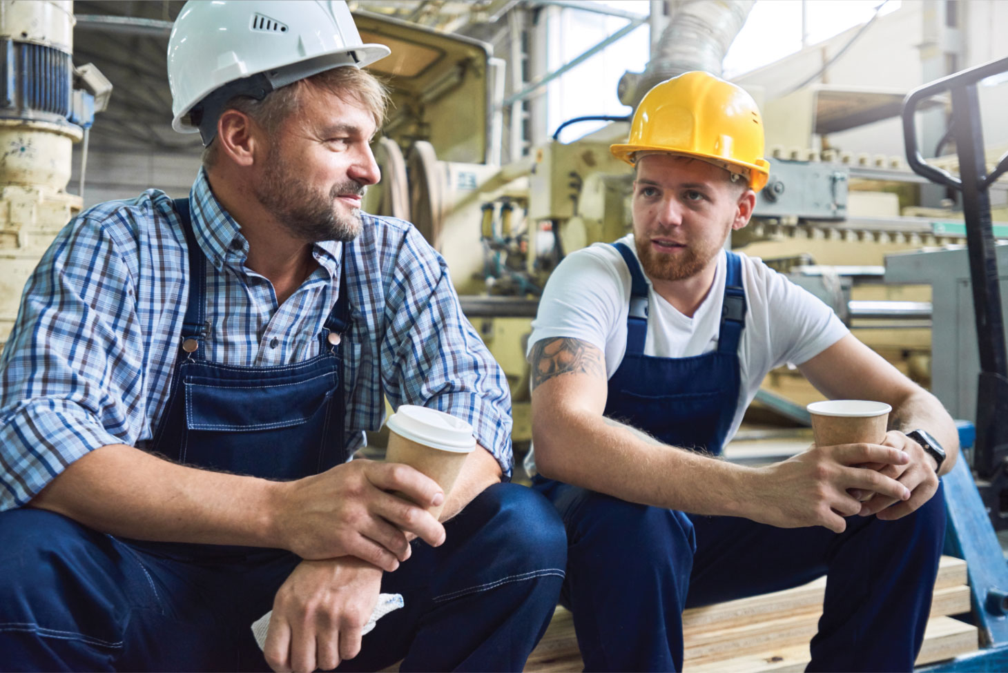 Two men in hardhats, having a chat