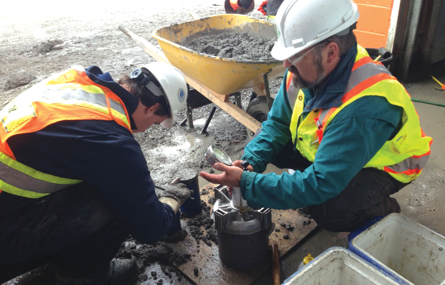 Workers on jobsite testing the air content of concrete