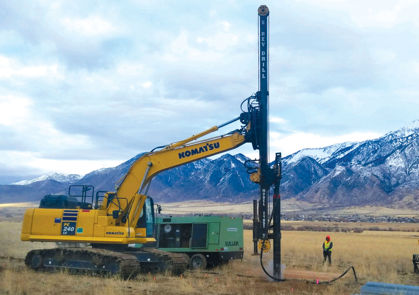 REV Drill in field with mountain range in background