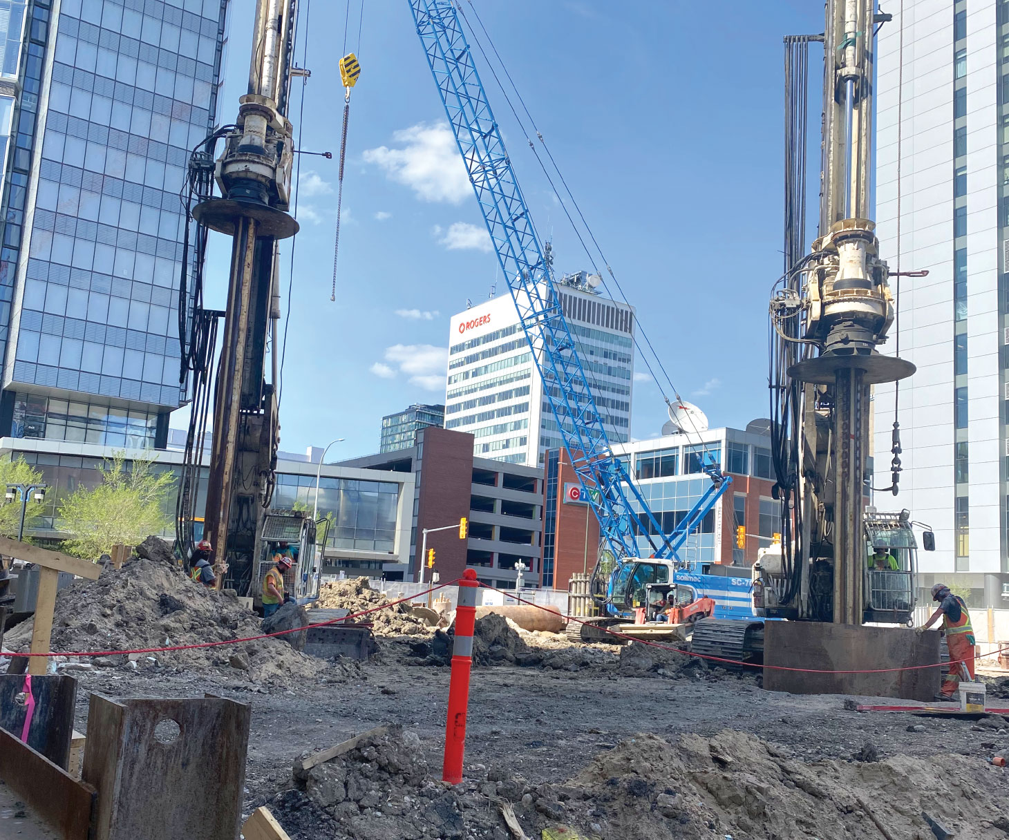 Foundation construction with commercial buildings in background